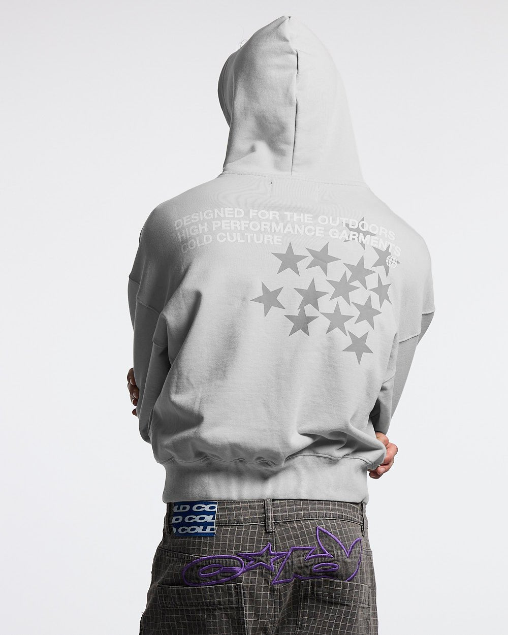 Source photograph: the hoodie worn hood-up from behind, the back print and hood seam visible